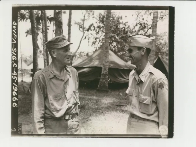Major General Charles E. Hurdis (L), commanding officer, 6th Infantry Division, congratulating 2nd Lt. Donald E. Rudolph on his promotion, June 27, 1945. Major General Charles E. Hurdis (L), commanding officer, 6th Infantry Division, congratulating 2nd Lt. Donald E. Rudolph on his promotion, June 27, 1945.