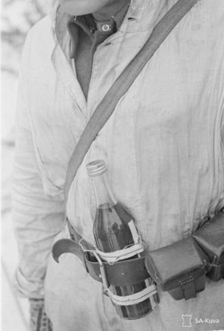 Finnish soldier with a Molotov cocktail. The Finns named the incendiary device after Vyacheslav Mikhaylovich Molotov, who signed the 1939 non-aggression pact with Germany just before the Russian invasion. Note contact detonator tube taped to bottle. The contact tube allowed the soldier to simply throw the bottle without lighting anything; the bottle exploded on impact. Photo credit SA-Kuva Molotov cocktail from the 1939 Soviet invasion of Finland Winter War