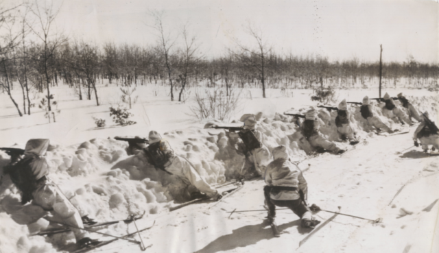 Soldiers on skis practice their marksmenship under simulated gas attacks during the 1939-40 winter exercises at Pine Camp, NY. Courtesy Doug Schmidt/National Association of the 10th Mountain Division, Inc. Soldiers on skis practice their marksmenship under simulated gas attacks during the 1939-40 winter exercises at Pine Camp, NY. Courtesy Doug Schmidt/National Association of the 10th Mountain Division, Inc.