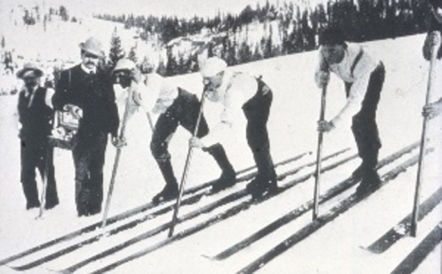 Starting line of a ski race in California ca. 1880s in CA. Note single pole, which was ubiquitous in early American skiing. The man with the box is selling dope (wax). The man behind him has a gong, which was used to start the race. All the mining camps in California in the late 1800s had skiing activity. Photo credit: New England Ski Museum